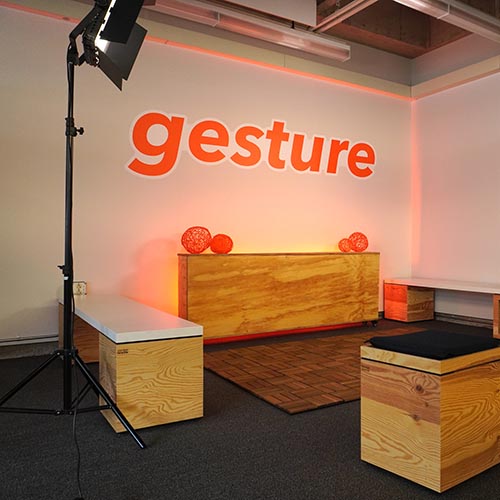 Room with gesture logo on wall