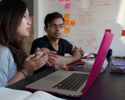 People looking at a laptop together