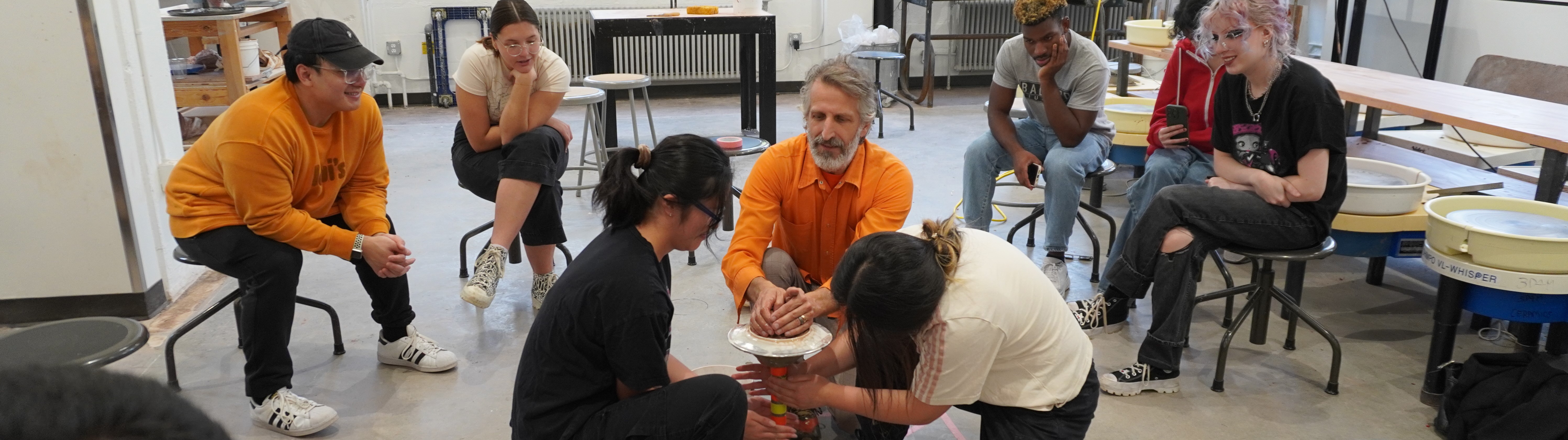 Students sitting with teacher