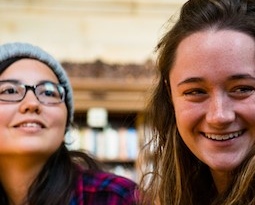 Two students in a classroom or library.