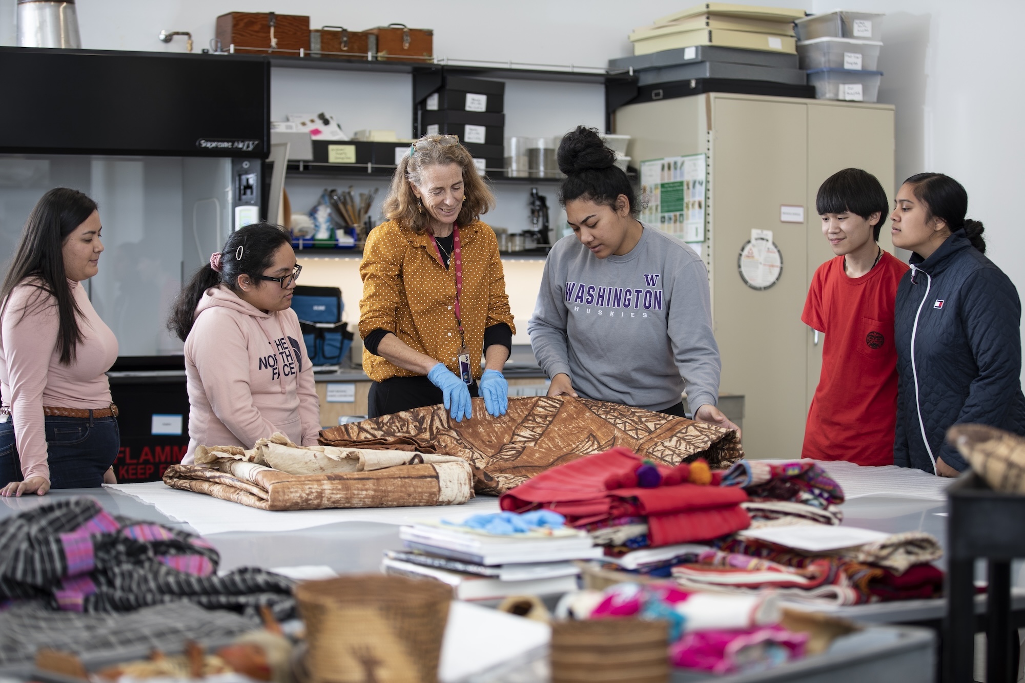 students working with professor holly barker in the Burke Museum